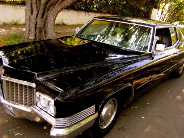 black 1970 cadillac coupe de ville / black and white interior
