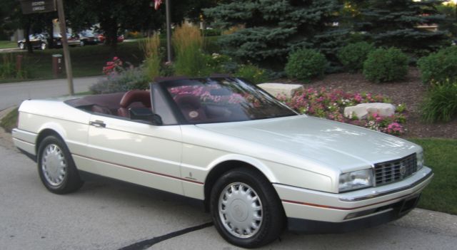 low mileage sports car in white pearl with red leather interior
