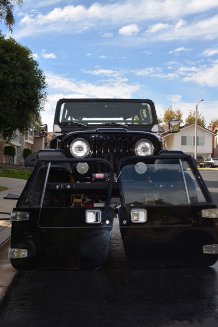 v8 powered 1984 jeep cj7 with genright roll cage and 4 inch rancho lift