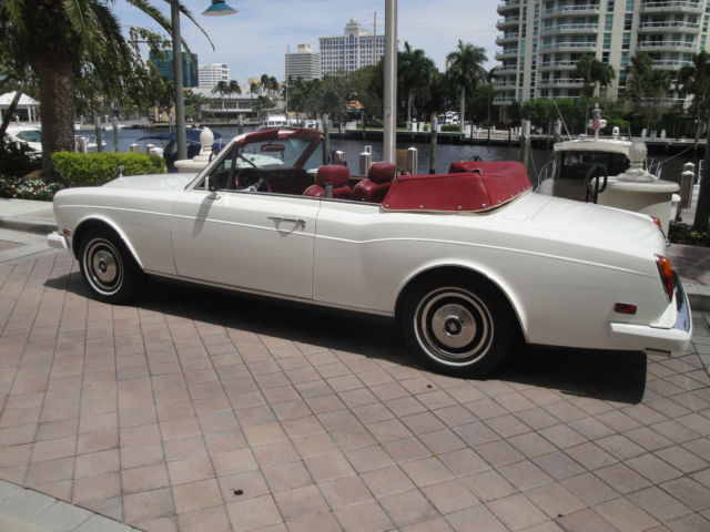 white convertible with burgundy leather interior; excellent condition