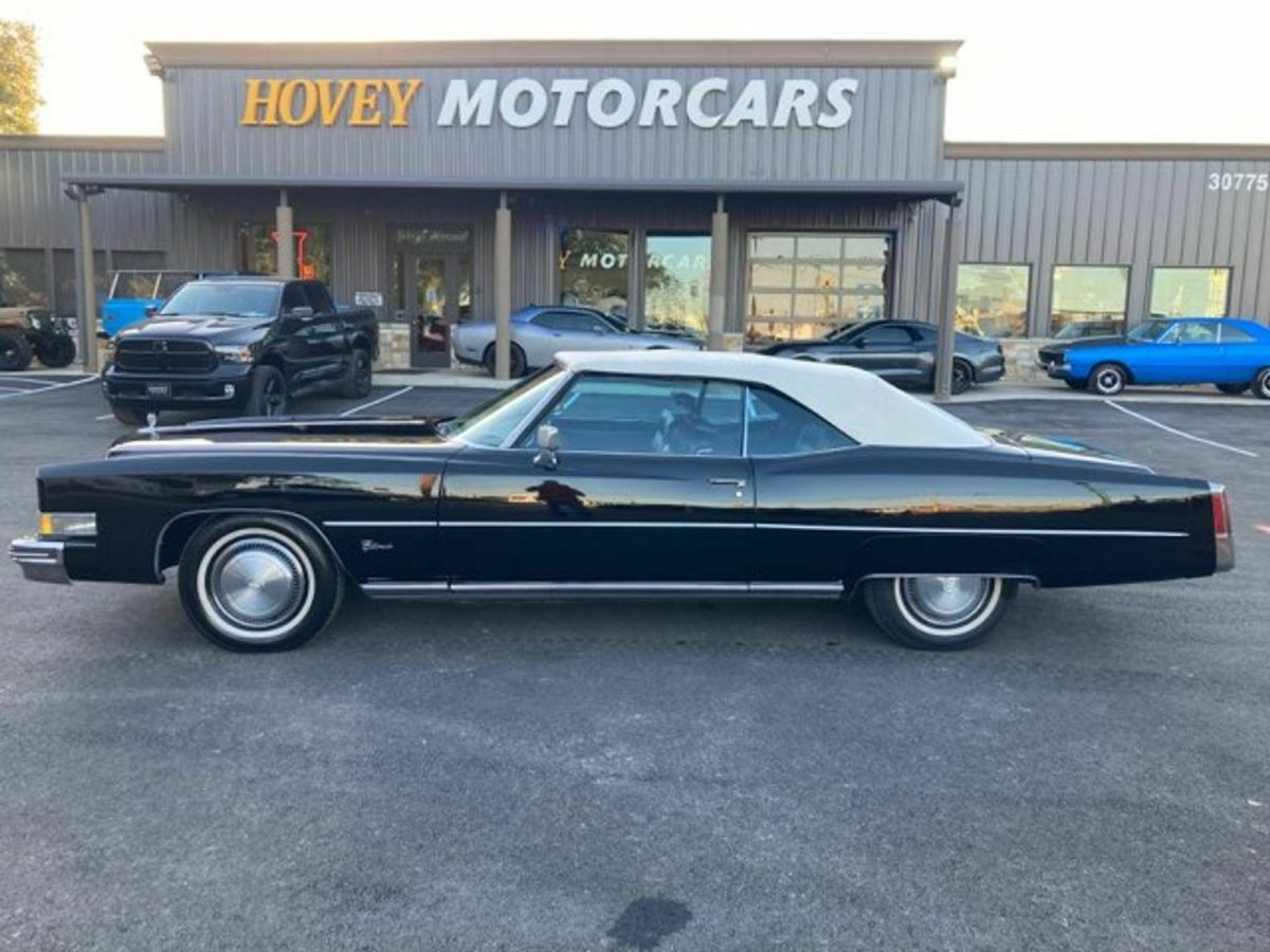 cadillac black with black leather interior, white convertible top, cold a/c
