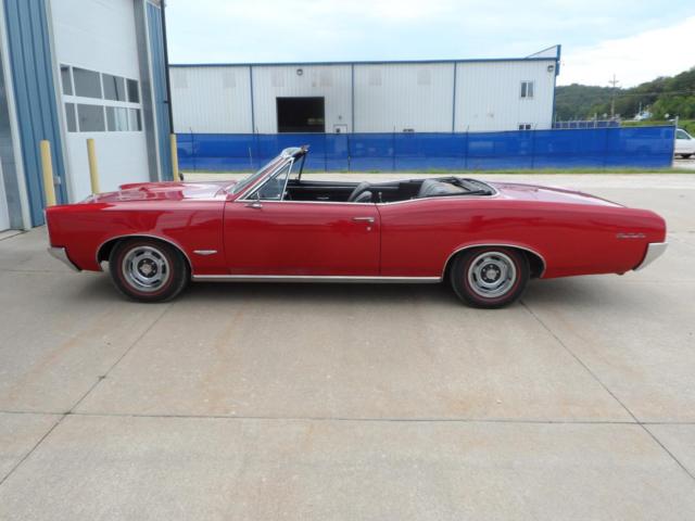 convertible, four speed, tri power, power top, power steering, red line tires