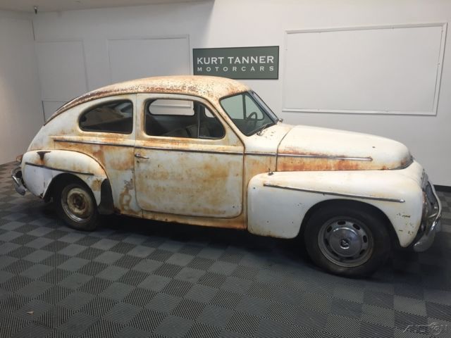 1958 volvo p444 sports coupe. white on red. 3-speed manual. nice original car