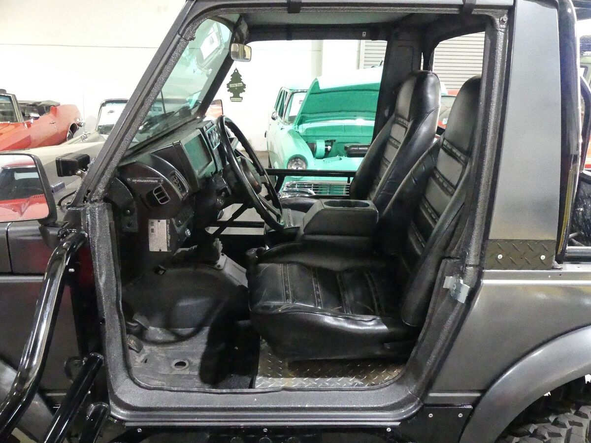 lifted with 35" tires, rock sliders, bumpers, roll bar, upgraded lights! 5-speed