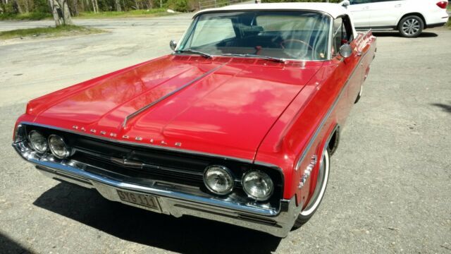 1964 oldsmobile with a 280 hp v8 and dual exhausts