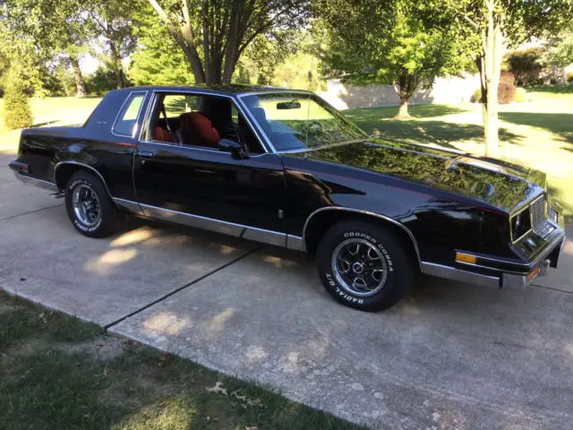1985 oldsmobile cutlass salon black with red pin strip
