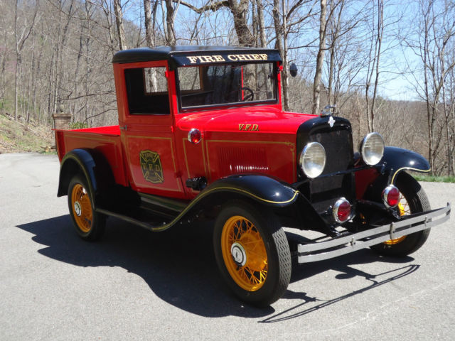 restored as fire chief truck: gold lettering & stripes, red lights, siren, bell