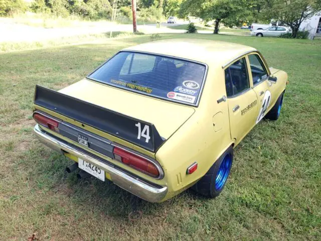 1976 nissan datsun sedan yellow rwd manual b210