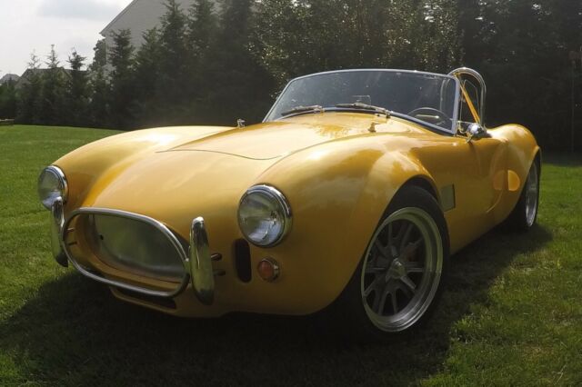 body of a classic innards of a tesla 1965 all electric shelby cobra