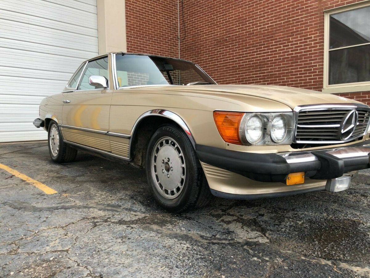 1974 mercedes 450sl gold with a dark brown interior