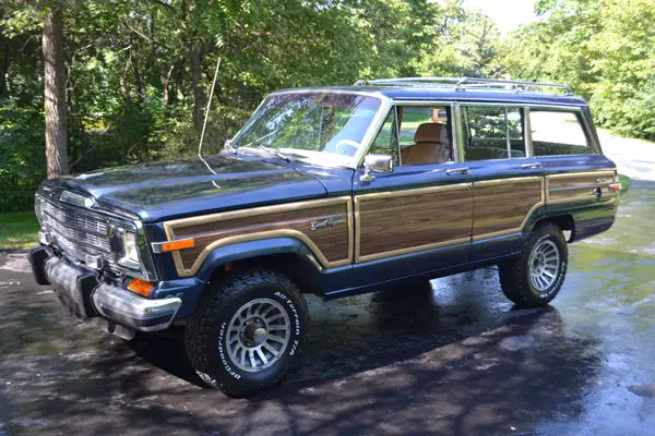 1989 jeep grand wagoneer. midnight blue metallic w/ desert sand leather interior