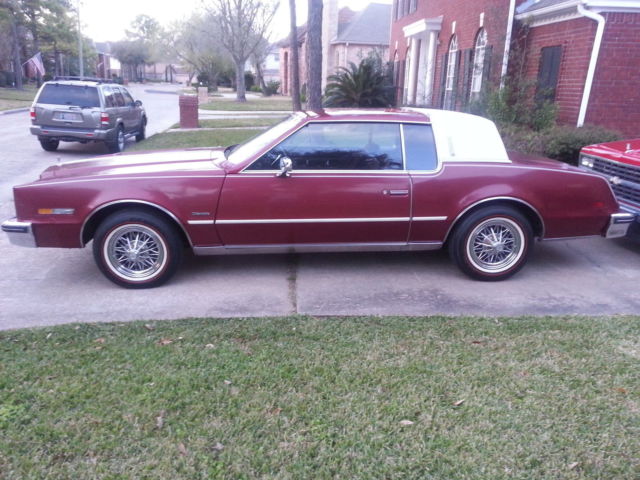 red with white vinyl top. sport wheels beginning to rust. have original hubcaps