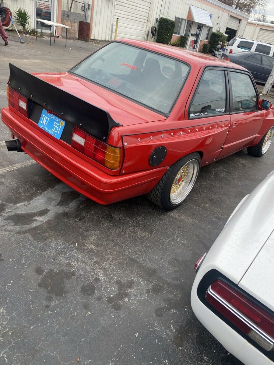 1988 bmw 325 sedan red rwd manual