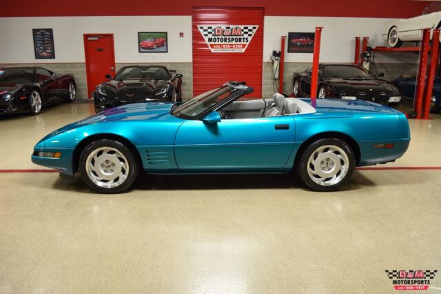 bright aqua metallic corvette convertible with 20745 miles we finance!