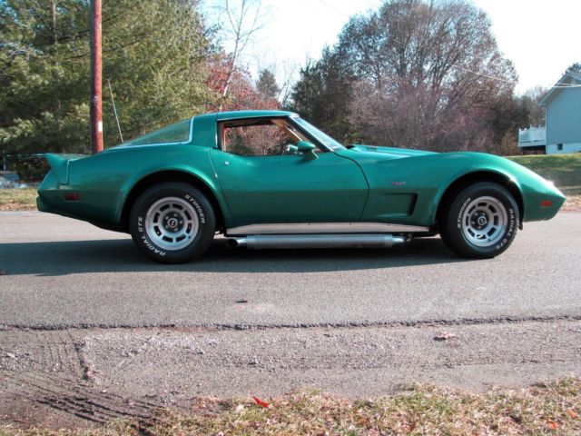 beautiful classic collector car repainted emerald green with side pipes headers
