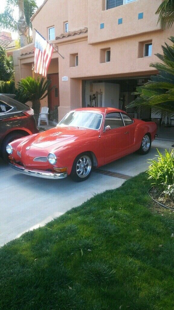 2-door salmon-colored karmann ghia coupe