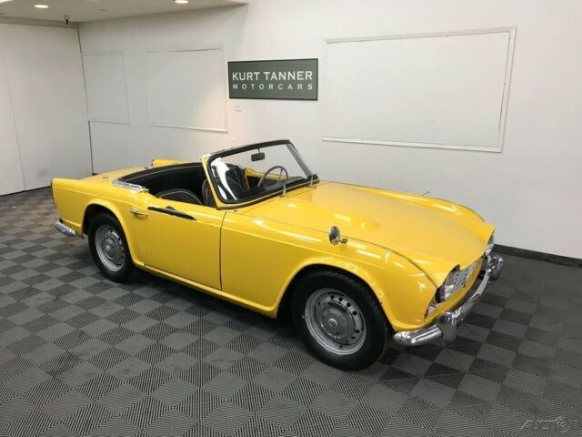 1962 triumph tr-4 roadster. yellow with black trim. 4-speed. painted dash car