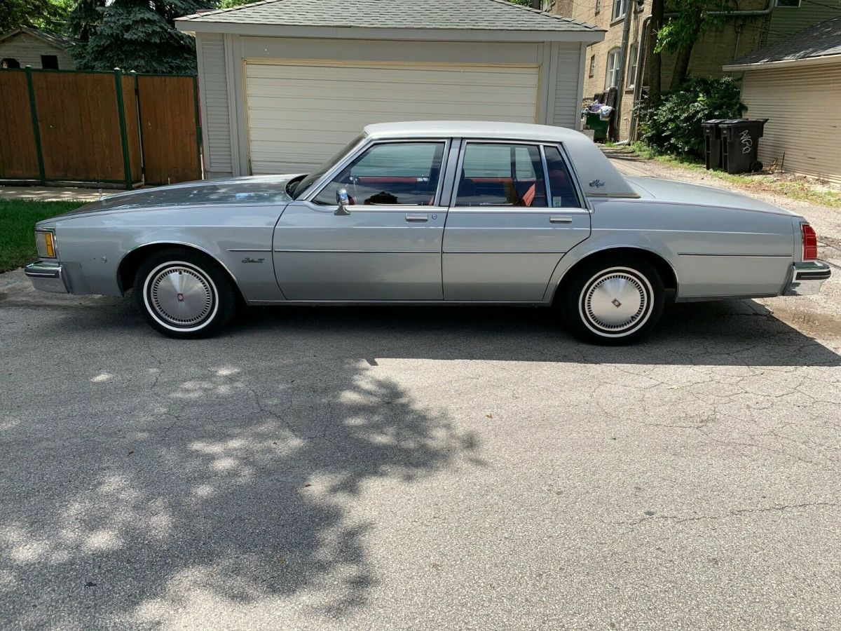 1981 oldsmobile 4 dr gray with red velour 33,197 miles