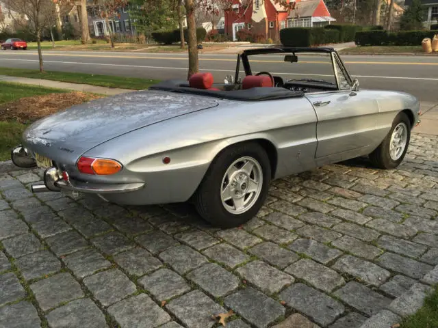silver with red leather interior. boat tail, duetto, excellent condition