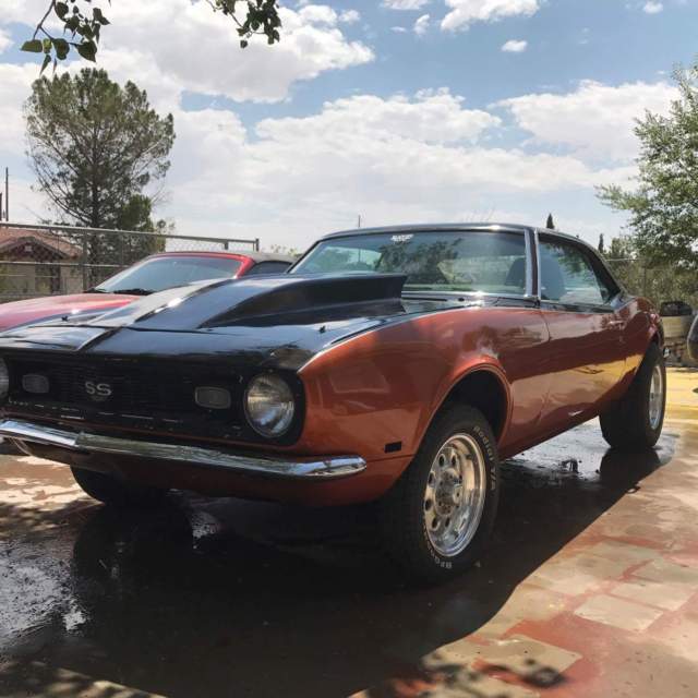 1968 orange and black chevy camaro supercharged
