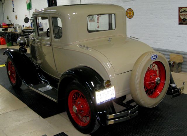 1930 deluxe coupe,frame-off resto,cream/black w/tan int,flat4,3spd,spokes,rumble