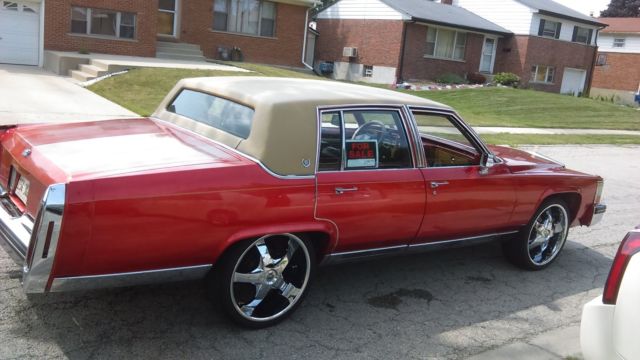 1985 cadillac fleetwood brougham, candy apple red, chrome grille, 22 inch tires
