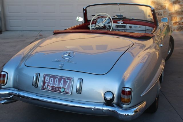 silver 1956 mercedes benz 190sl convertible roadster with red leather interior