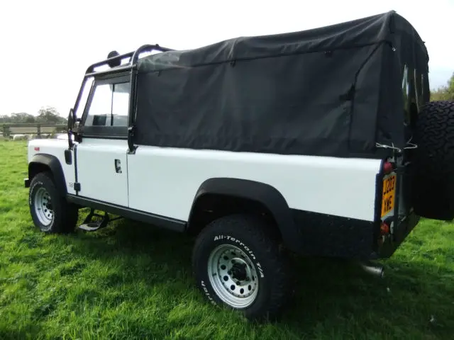 land rover defender white beach truck