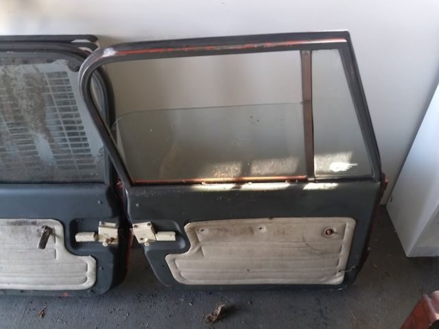 jeep cj set of full steel doors, one door has sawdust on it