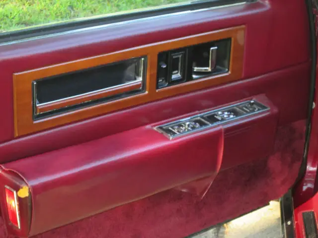 1989 red two door with gold grill loaded
