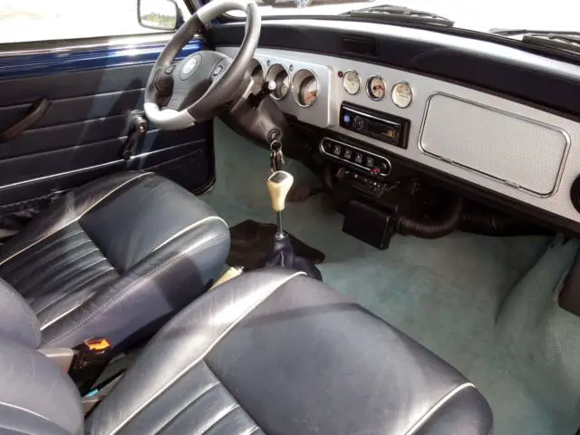 blue classic morris mini with sunroof and modern conveniences