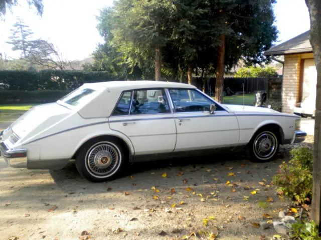 cool cadillac 1985 seville, white/white top, looks mint, runs good, check it out
