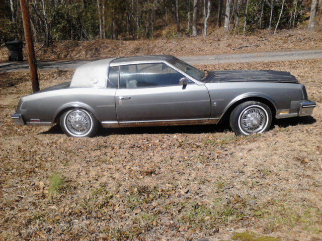 grey buick riviera, basket spoke wheels, no rust, excellent interior and ext