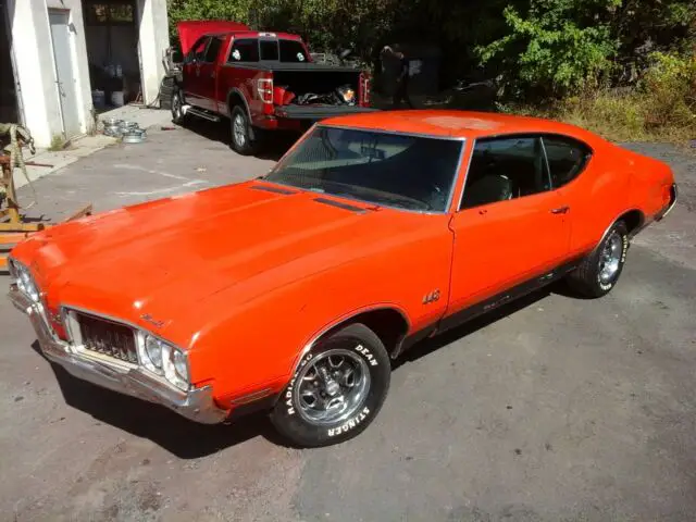 70 olds 442 # matching original rally red, black bucket seat, console ,dual gate