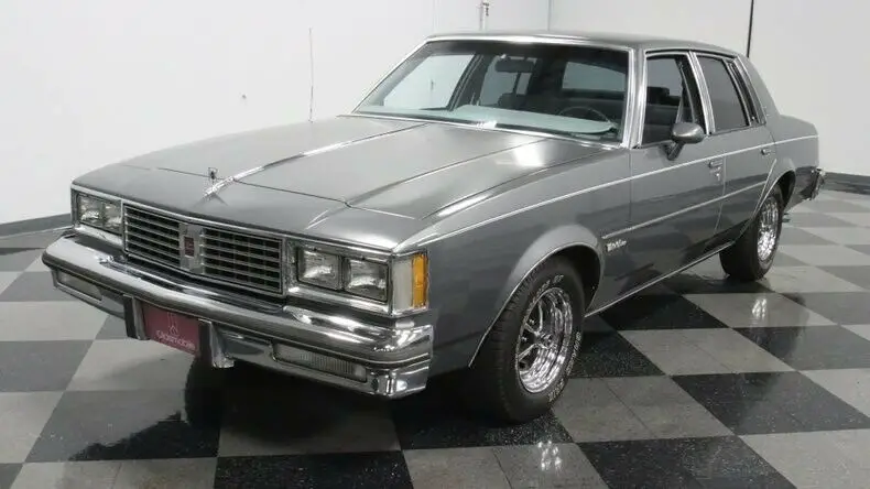 classic vintage chrome olds supreme 5.0 liter v8 auto transmission gray