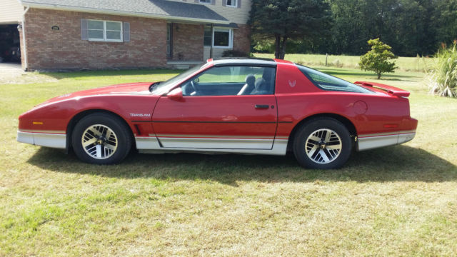 1985 red and gray pontiac trans am in good condition