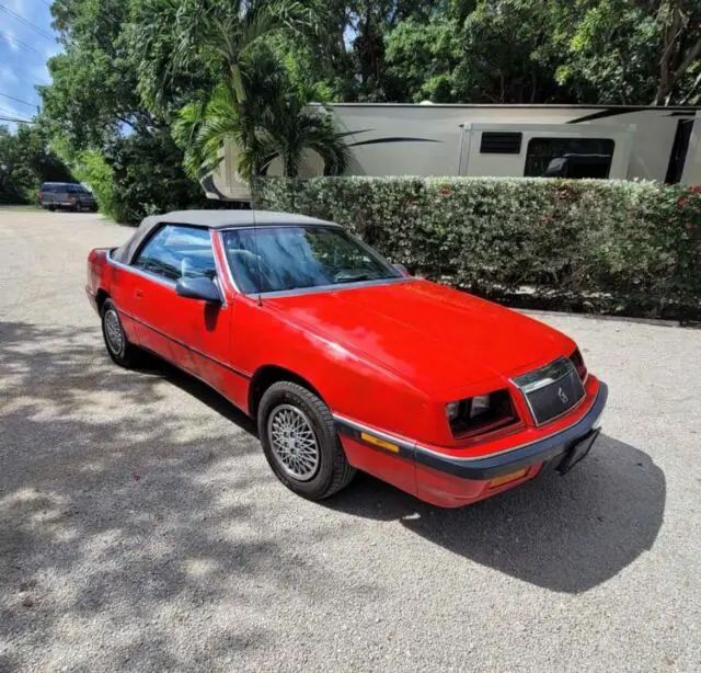 1991 red chrysler labaron convertible beach island cruiser car