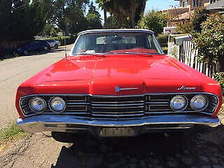 this 1967 mercury monterey is shown in a tomato red exterior with red/white inte