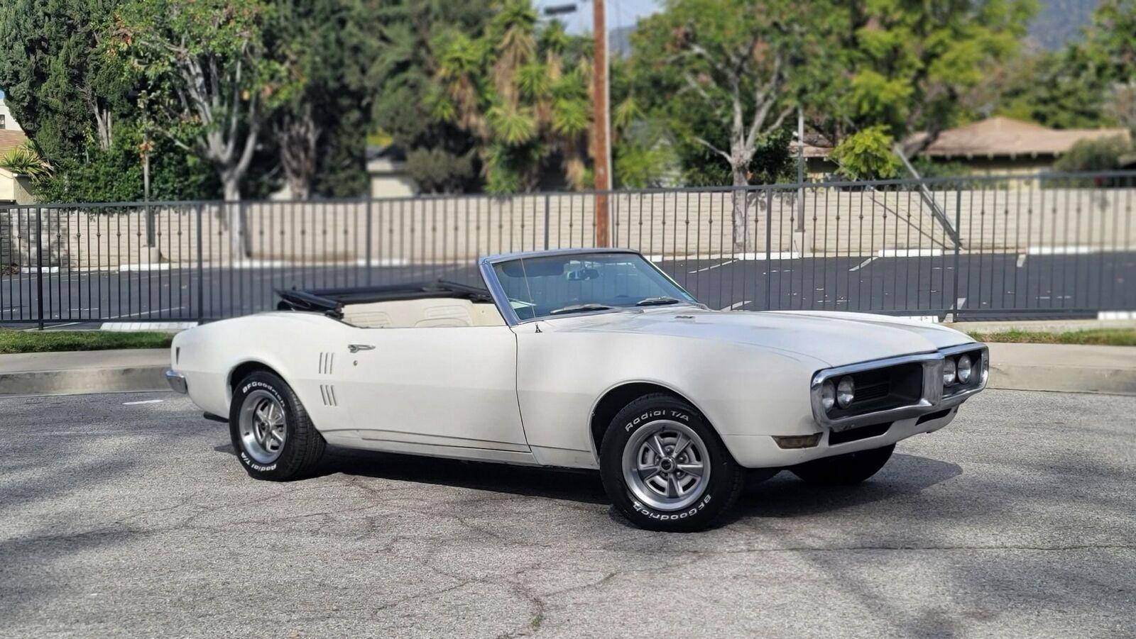 1968 pontiac firebird white exterior with a black soft top