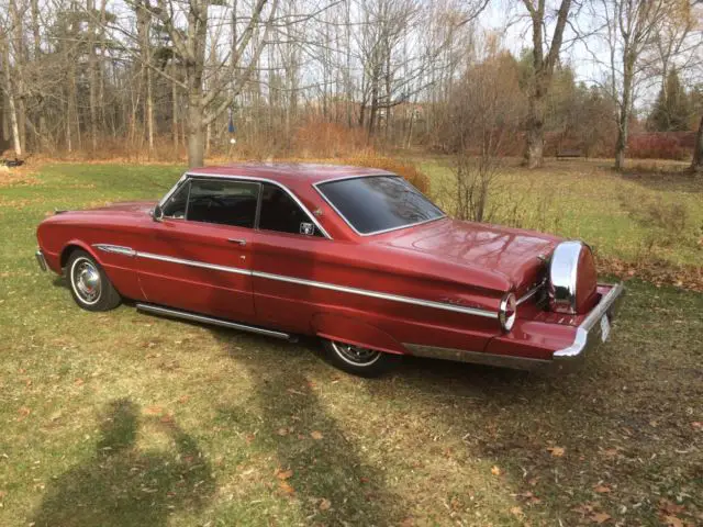 futura. 6-cyl. bench seat automatic. burgandy. continental kit, lakes & skirts